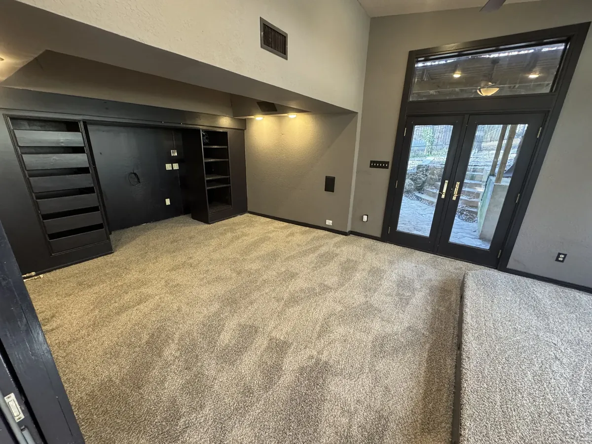 Room with dark built-ins and newly installed carpet after flooring remodel in San Antonio, TX